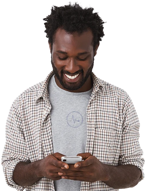 a guy on his phone smiling at his newly improved credit score